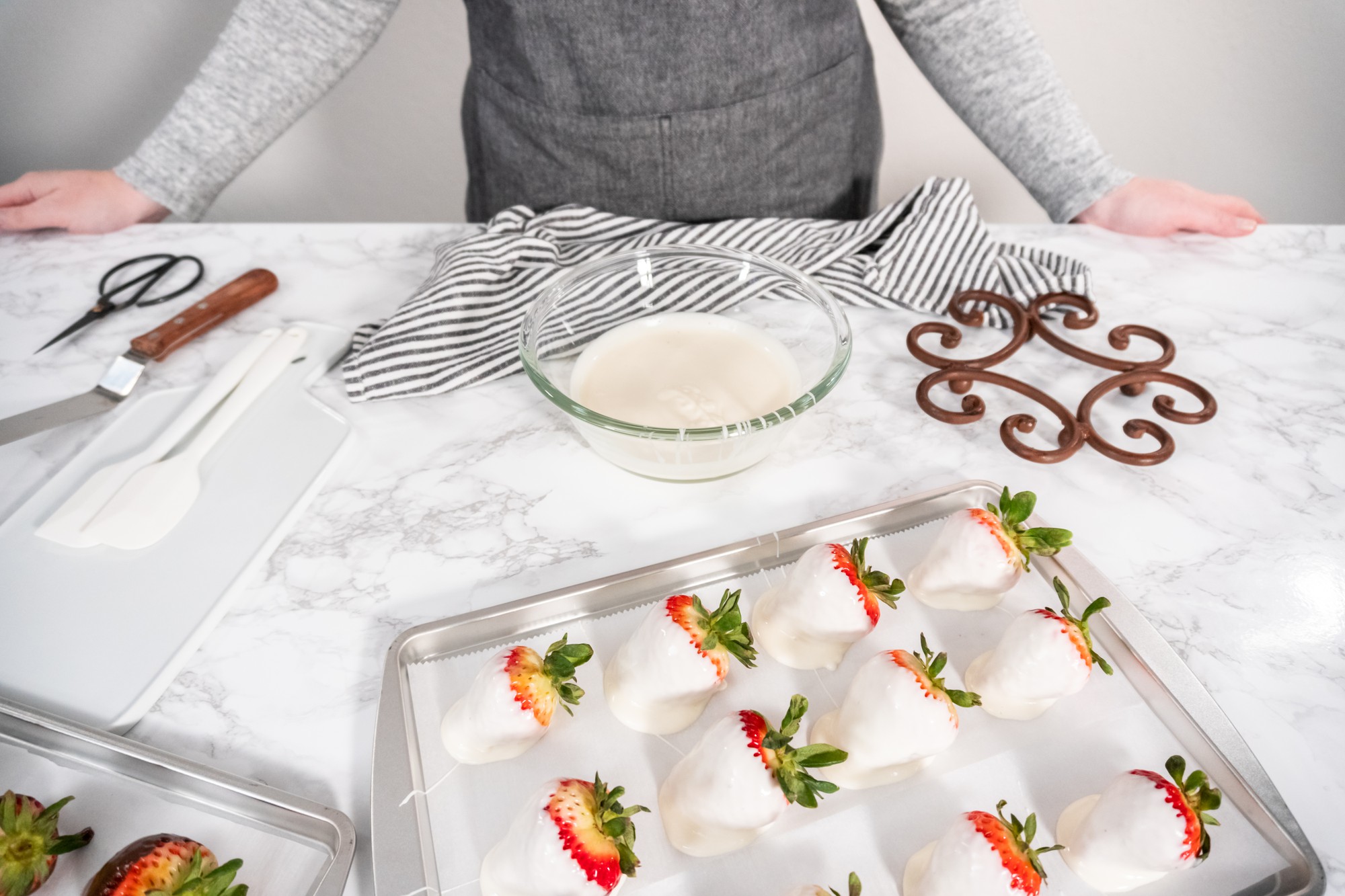 Hands preparing mise en place trays